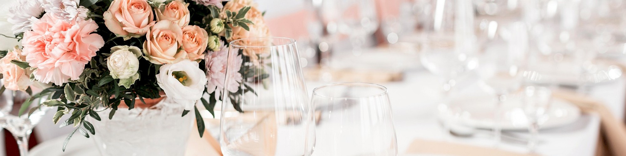 Wedding Table for 20 decorated with flowers, plates and glasses